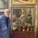Artist Jim Ingwersen Posing with Portrait inside Gallery